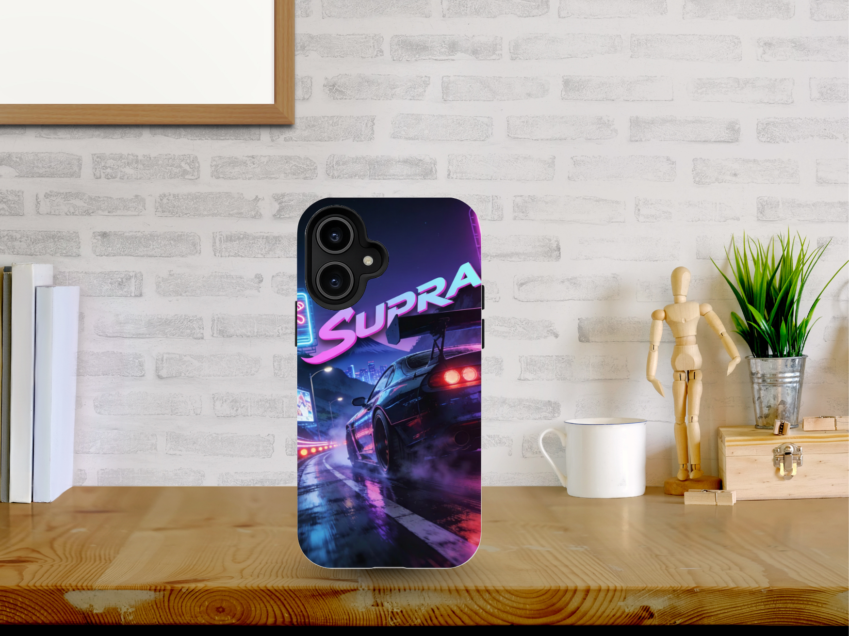 Phone case with 'Supra' design on a desk with a brick wall background