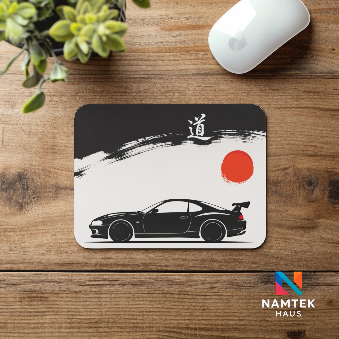 Mouse pad with car design on a wooden desk, featuring the brand 'Namtek Haus'.